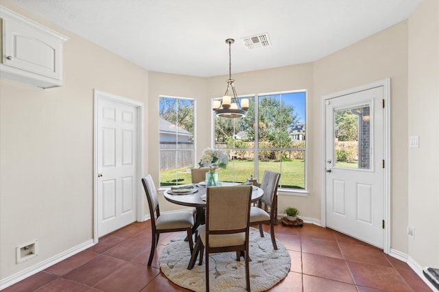 dining space with dark tile patterned flooring