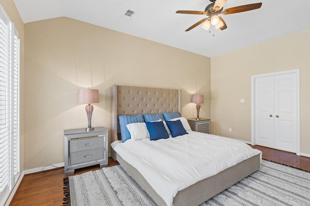 bedroom with hardwood / wood-style floors, ceiling fan, vaulted ceiling, and a closet