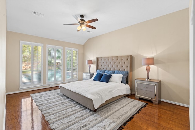 bedroom with ceiling fan, wood-type flooring, and lofted ceiling