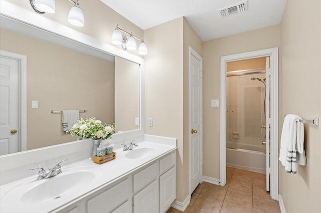 bathroom with vanity, tile patterned floors, and tiled shower / bath