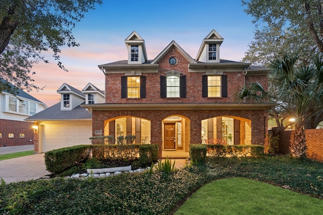 colonial home with a porch and a garage