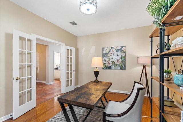 office area with wood-type flooring and french doors