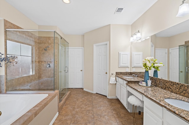 bathroom with tile patterned floors, vanity, and shower with separate bathtub