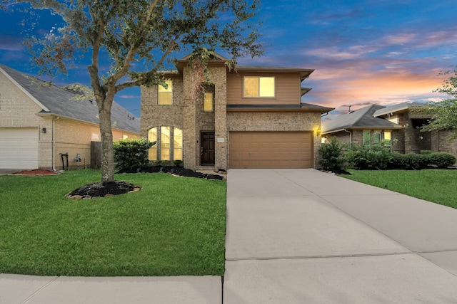 view of front of property featuring a yard and a garage