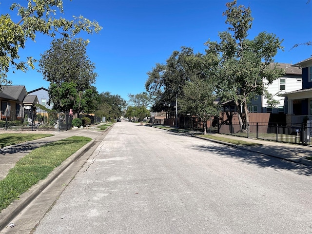 1201 Walton St, Houston, TX 77009 - view of asphalt road featuring sidewalks, curbs, and a residential view