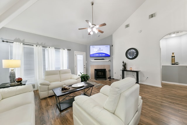 living room featuring ceiling fan, a fireplace, high vaulted ceiling, and dark hardwood / wood-style floors