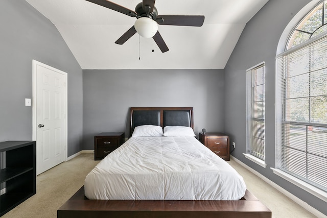 bedroom featuring ceiling fan, light carpet, and vaulted ceiling