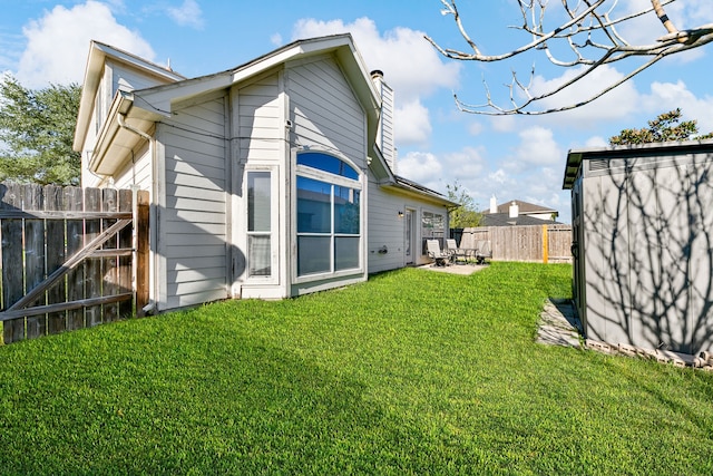 back of property with a patio and a lawn