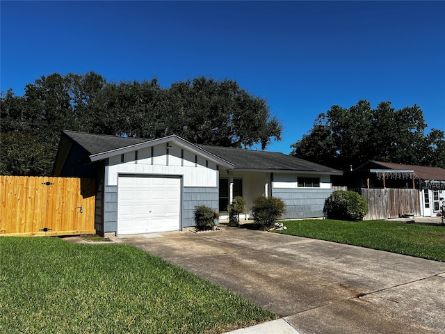 single story home featuring a front lawn and a garage