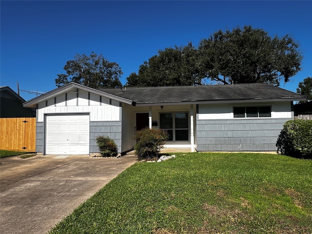 ranch-style house with a garage and a front lawn