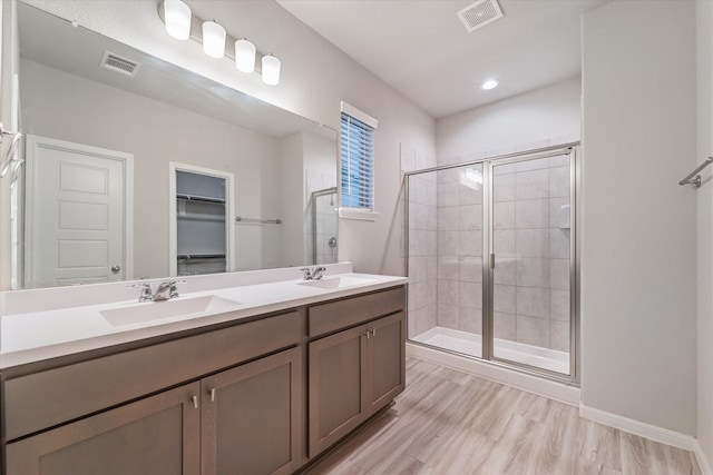 bathroom featuring vanity, an enclosed shower, and hardwood / wood-style flooring