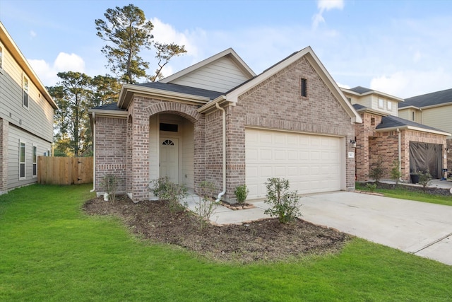 view of front of property featuring a garage and a front lawn