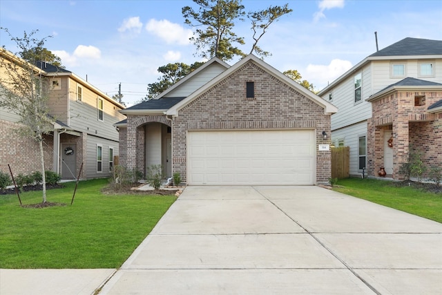 view of front of property featuring a front yard and a garage