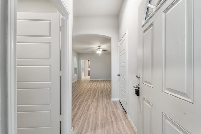 corridor with light hardwood / wood-style floors