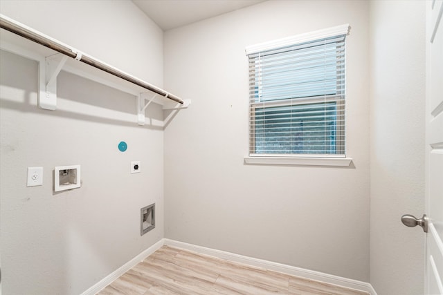 clothes washing area featuring hookup for an electric dryer, hookup for a washing machine, and light hardwood / wood-style flooring