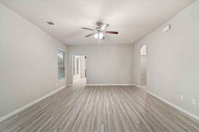 unfurnished room with ceiling fan and light wood-type flooring