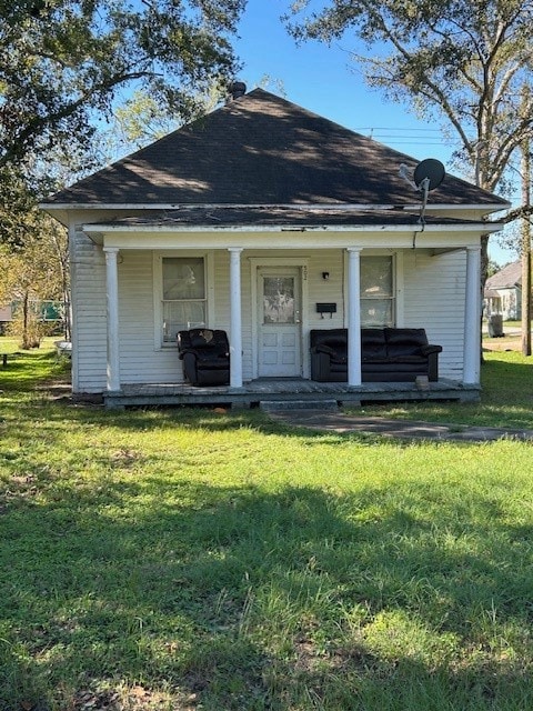 bungalow-style house with a front yard and a porch