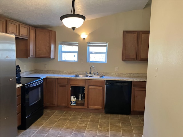 kitchen with black appliances, pendant lighting, sink, and vaulted ceiling