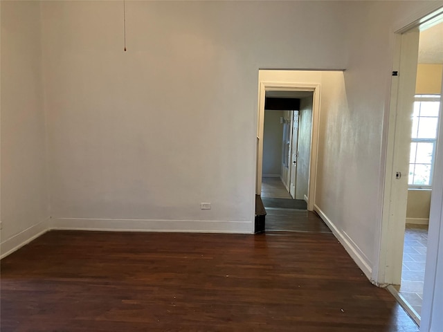 empty room with dark hardwood / wood-style floors