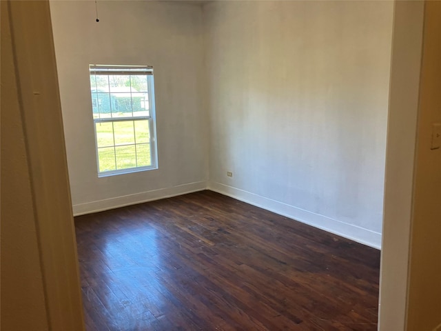 unfurnished room featuring dark wood-type flooring