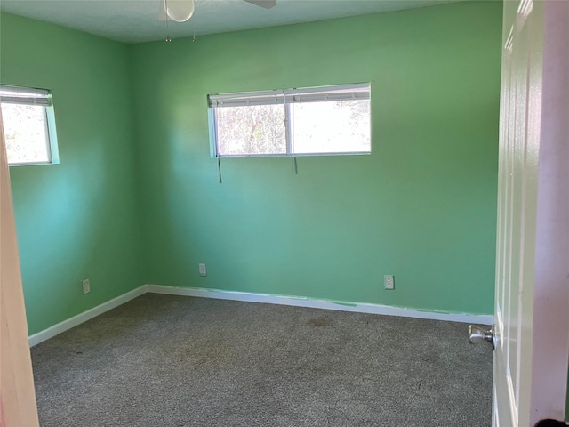 carpeted empty room with a wealth of natural light and ceiling fan