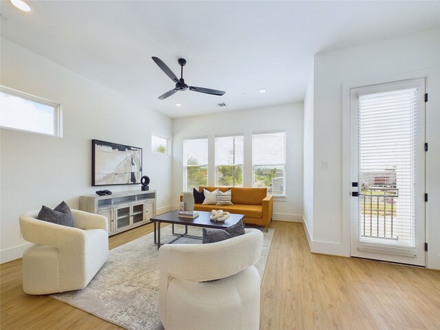 living room with ceiling fan and light wood-type flooring