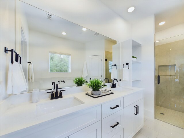 bathroom featuring vanity, tile patterned floors, and walk in shower