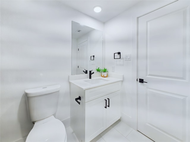 bathroom featuring tile patterned floors, vanity, and toilet