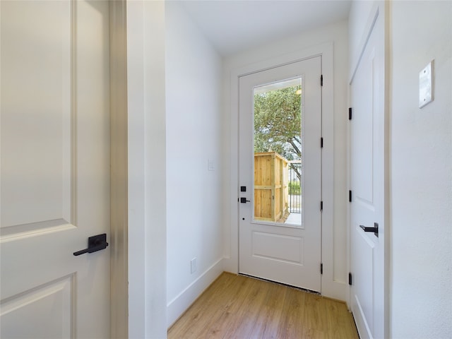 doorway to outside with light wood-type flooring