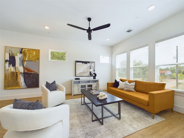 living room with ceiling fan, a healthy amount of sunlight, and light hardwood / wood-style floors