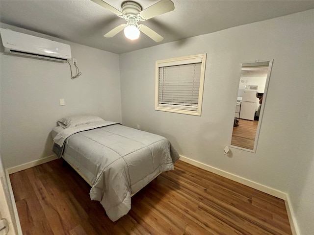 bedroom featuring a wall mounted air conditioner, dark hardwood / wood-style floors, and ceiling fan