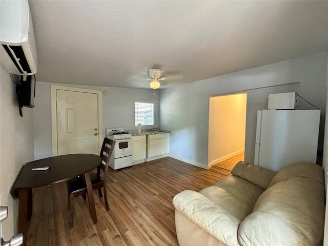 living room with light hardwood / wood-style flooring and ceiling fan