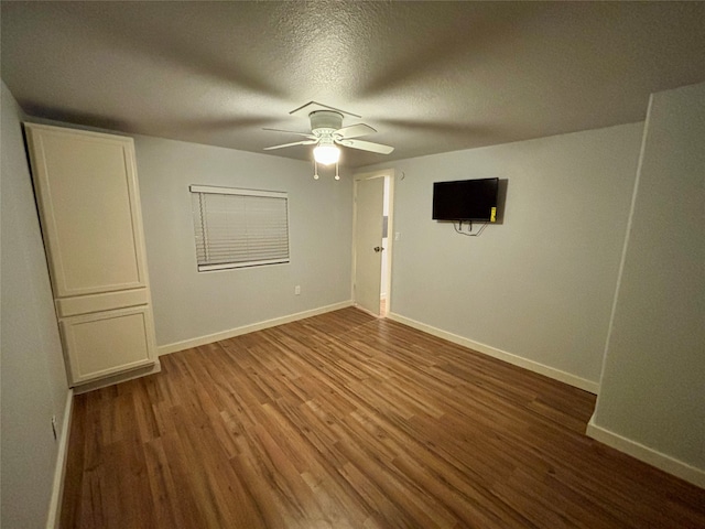 unfurnished room featuring ceiling fan, a textured ceiling, and hardwood / wood-style flooring