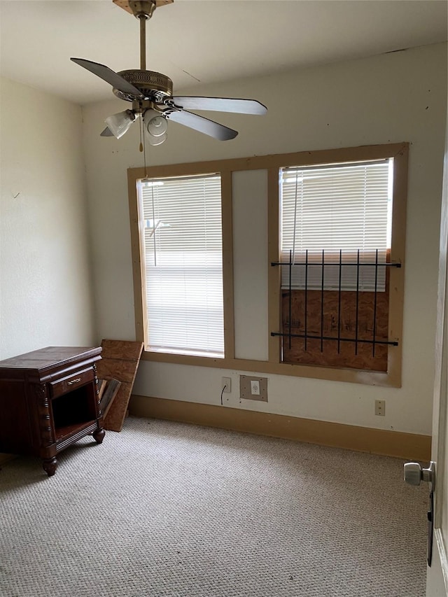 empty room featuring carpet flooring and ceiling fan