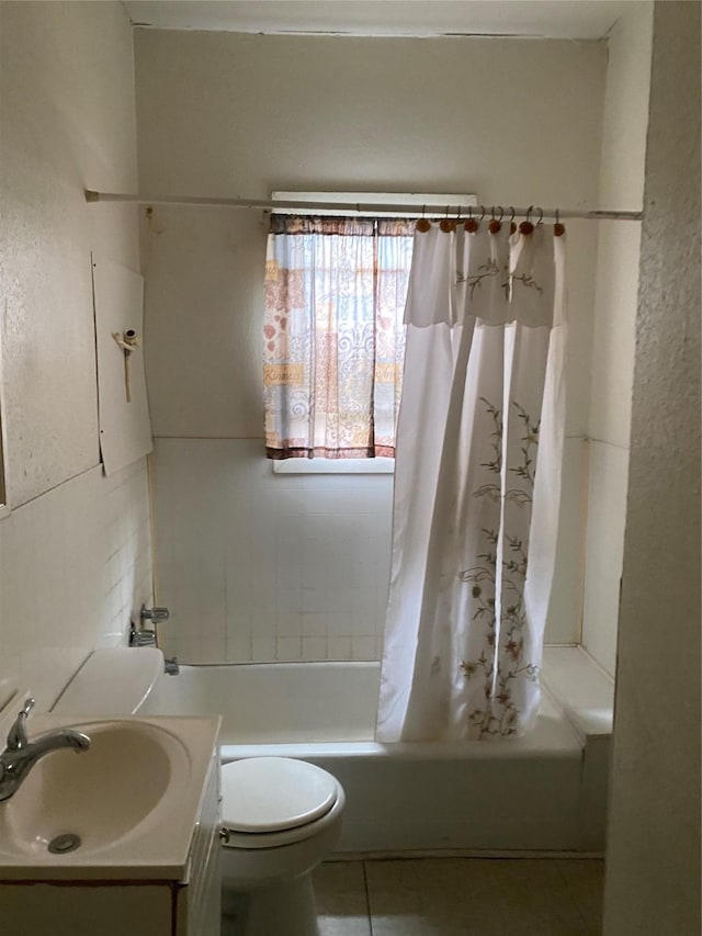 full bathroom featuring tile patterned floors, vanity, toilet, and shower / bath combo with shower curtain