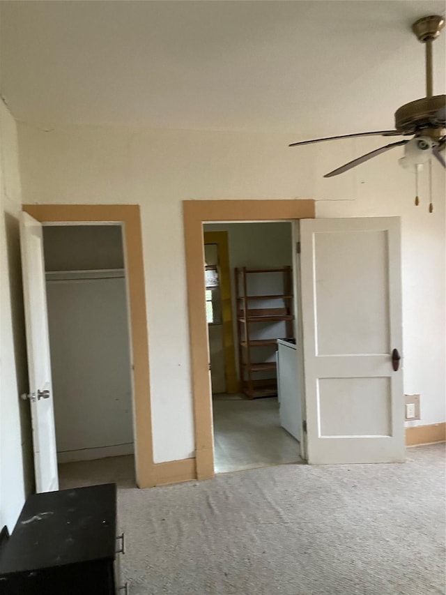 unfurnished bedroom featuring light carpet and ceiling fan