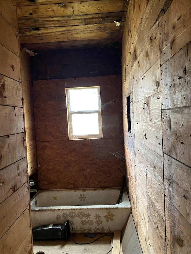 4412 Orange St, Houston, TX 77020 - bathroom featuring a tub to relax in and wood walls