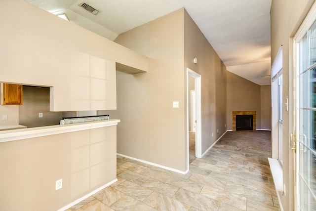 kitchen featuring white cabinets and lofted ceiling