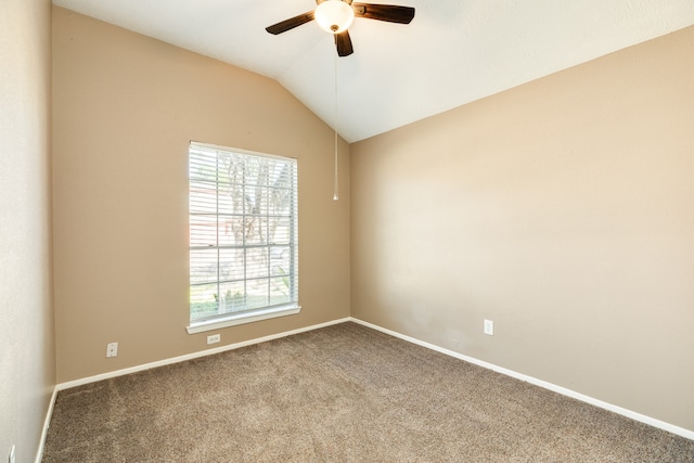 carpeted empty room with vaulted ceiling, ceiling fan, and a healthy amount of sunlight