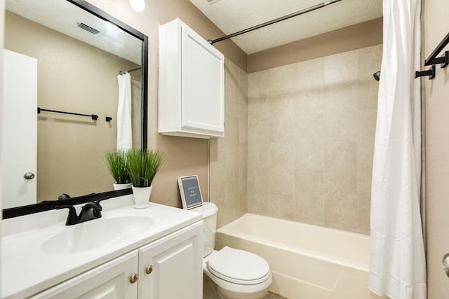 full bathroom with vanity, toilet, a textured ceiling, and shower / tub combo