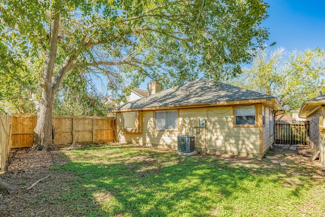 rear view of property with a lawn