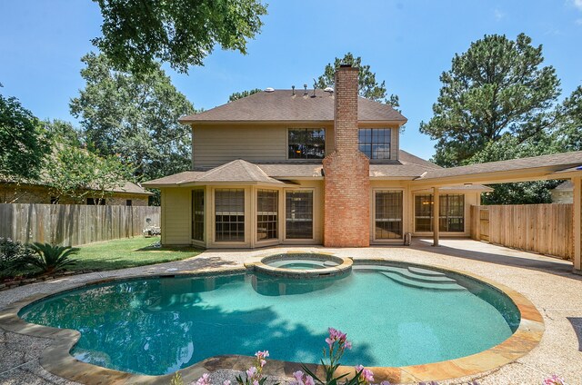 view of pool with an in ground hot tub and a patio