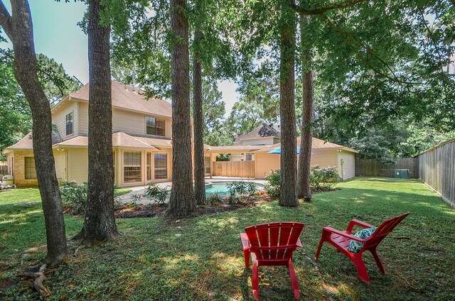 view of yard with a fenced in pool