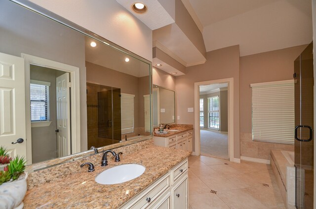 bathroom featuring tile patterned flooring, vanity, and walk in shower