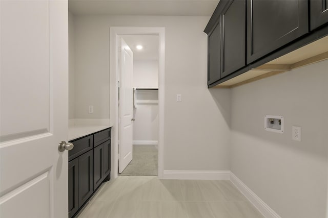 laundry area with cabinet space, hookup for a washing machine, and baseboards