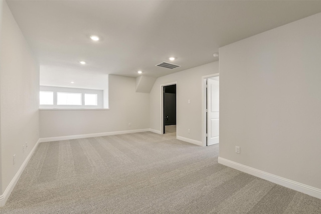 spare room with recessed lighting, visible vents, baseboards, and light carpet