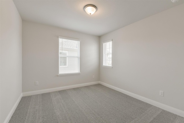 spare room with carpet floors and baseboards
