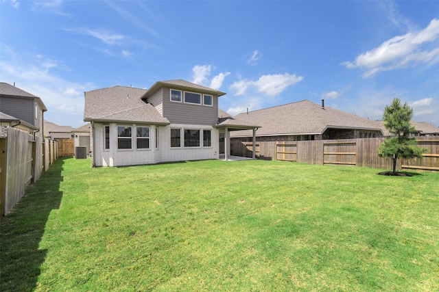 back of property with a lawn, central AC unit, roof with shingles, and a fenced backyard