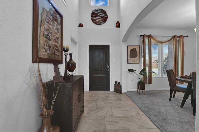 view of carpeted entrance foyer