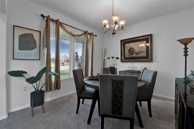 dining space featuring a notable chandelier and carpet floors